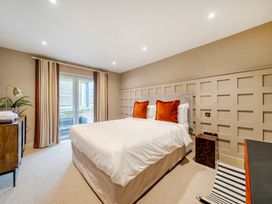 A bedroom with a bed and side table at Bell House in Llanfechell