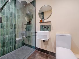 A bathroom with a shower, toilet, and sink at Bell House in Llanfechell