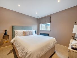 A bedroom with a bed and a window at Bell House in Llanfechell