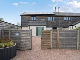 A house with gates and gravel pathway at Bell House in Llanfechell