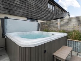 A hot tub with steps in an outdoor area at Bell House Llanfechell