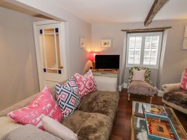 A living room with a sofa and television at 23 New Church Street Tetbury
