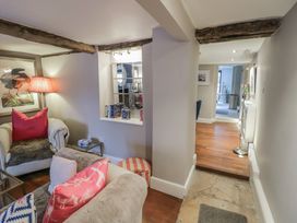 A living room with a sofa and lamp at 23 New Church Street Tetbury