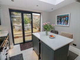 A kitchen with an island and sliding doors leading to an outdoor area at 23 New Church Street Tetbury