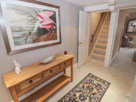 A hallway with a console table and a painting at 23 New Church Street, Tetbury