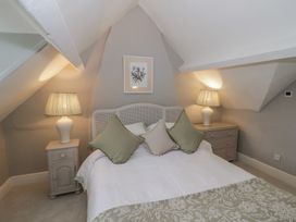 A bedroom with a bed and nightstands at 23 New Church Street Tetbury