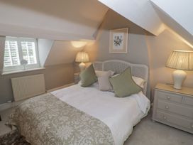 A bedroom with a bed and bedside tables at 23 New Church Street in Tetbury