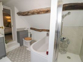 A bathroom with a bathtub, shower, sink, and toilet at 23 New Church Street Tetbury