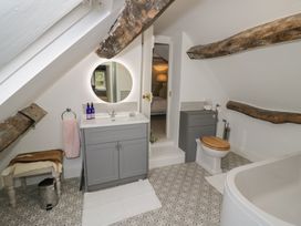 A bathroom with a bathtub and sink at 23 New Church Street Tetbury