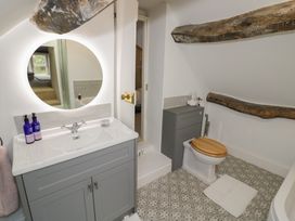 A bathroom with a sink, mirror and toilet at 23 New Church Street Tetbury