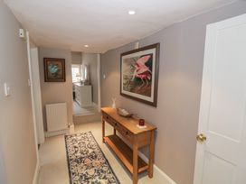 A hallway with a console table and artwork at 23 New Church Street, Tetbury