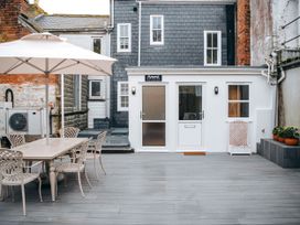 An outdoor area with a table and chairs at Ammil Bespoke