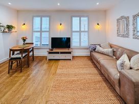 A living room with a sofa and dining table at Ammil Bespoke