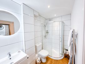 A bathroom with a shower, toilet, and sink at Ammil Bespoke 