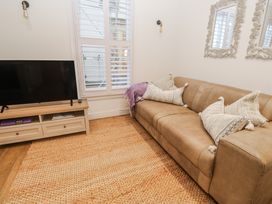 A living room with a television and sofa at Ammil Bespoke in St Ives