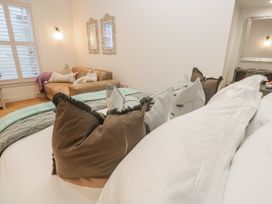 A bedroom with pillows and a sofa at Ammil Bespoke in St Ives
