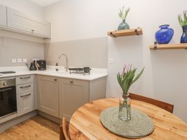 A kitchen with a table and vase at Ammil Bespoke in St Ives