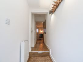 A hallway with a staircase and a radiator at Ammil Bespoke in St Ives