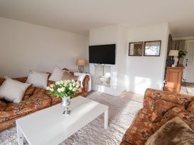 A living room with a television and a coffee table at Three Ways South Lopham near Garboldisham