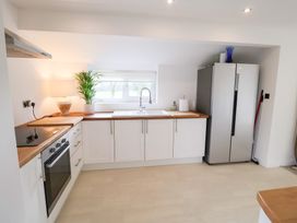 A kitchen with a sink and refrigerator at Three Ways South Lopham near Garboldisham