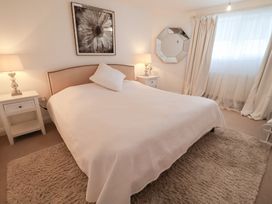 A bedroom with a bed and nightstands at Three Ways in South Lopham near Garboldisham