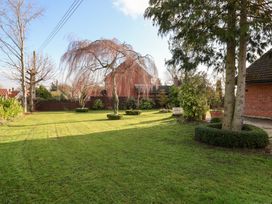 A garden with trees and grass at Three Ways South Lopham near Garboldisham