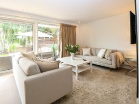 A living room with sofas, a coffee table, and a television at Three Ways South Lopham near Garboldisham
