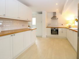 A kitchen with cabinets and appliances at Three Ways in South Lopham near Garboldisham