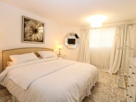 A bedroom with a bed and nightstand at Three Ways South Lopham near Garboldisham