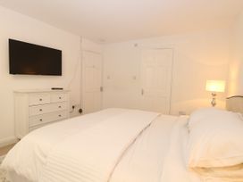 A bedroom with a bed and dresser at Three Ways in South Lopham near Garboldisham