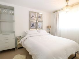 A bedroom with a bed and wardrobe at Three Ways South Lopham near Garboldisham