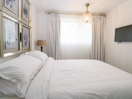 A bedroom with a bed and wall art at Three Ways in South Lopham near Garboldisham