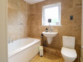 A bathroom with bathtub and sink at Three Ways in South Lopham near Garboldisham