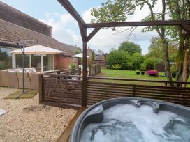 A garden with a hot tub and outdoor furniture at Three Ways South Lopham near Garboldisham