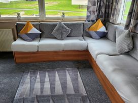 A living room with a sofa and cushions at Elm 33 in Scarborough