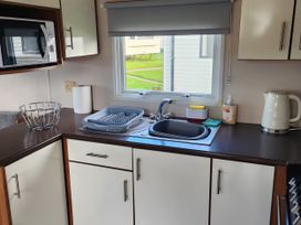 A kitchen with a sink and microwave at Elm 33 in Scarborough