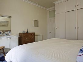 A bedroom with a bed and a dresser at 4 Ringrone in Salcombe