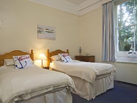 A bedroom with two beds and a dresser at 4 Ringrone Salcombe