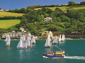 A view of sailboats and a ferry boat on water at 4 Ringrone Salcombe