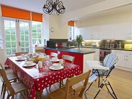 A kitchen with a dining table set for breakfast at 4 Ringrone in Salcombe