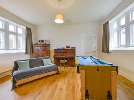 A recreation room with a pool table and piano at School House in Ivybridge