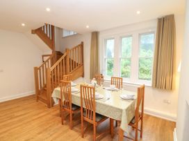 A dining room with a table set for meals at School House in Ivybridge