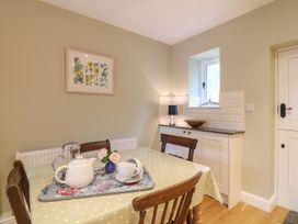A kitchen with a table set for tea at School House in Ivybridge