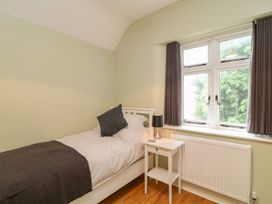 A bedroom with a bed and a nightstand at School House in Ivybridge
