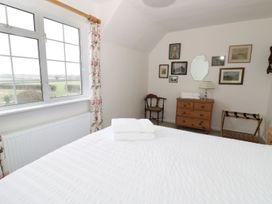 A bedroom with a bed and window at Glencoe Cottage in Broadway