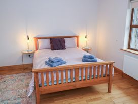 A bedroom with a bed and bedside table at Tigh Marie 