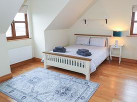 A bedroom with a bed and towels on top at Tigh Marie