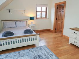 A bedroom with a bed and bedside table at Tigh Marie 