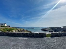 A view of the sea with a house in the background at Tigh Marie 
