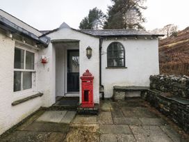An entrance with a red post box and stone wall at Newlands Fell House near Keswick
